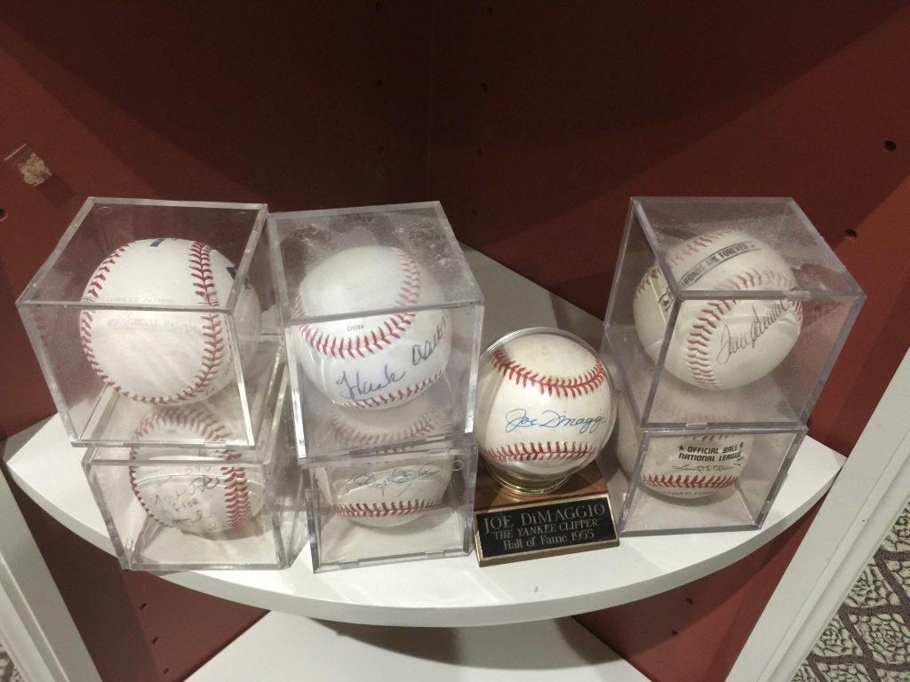 Signed game balls by the likes of Hank Aaron and Joe DiMaggio number among the collectibles at the Jamail estate sale. 