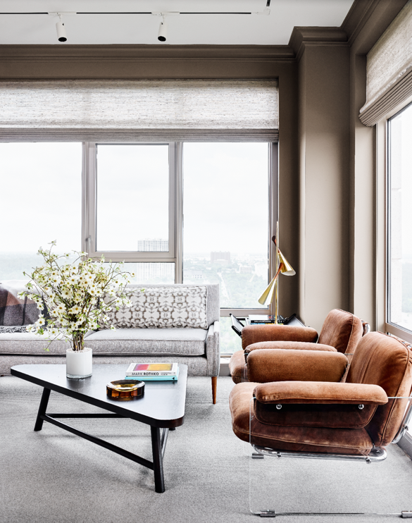 In the study, vintage Paul McCobb sofa with Zimmer + Rohde fabric from George Cameron Nash. Vintage Pace Collection Lucite-and-suede chairs. Vintage T.H. Robsjohn-Gibbings triangle table. 1950s brass lamp. Conrad window coverings from The Shade Store.