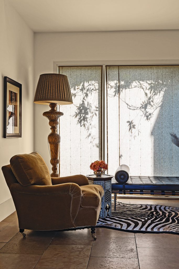 Mohair chair from George Smith. Indian
mother-of-pearl-inlaid table from William Lipton, NY. Zebra rug purchased at auction. Carved wooden lamp and custom shade, from William Gardner Antiques.