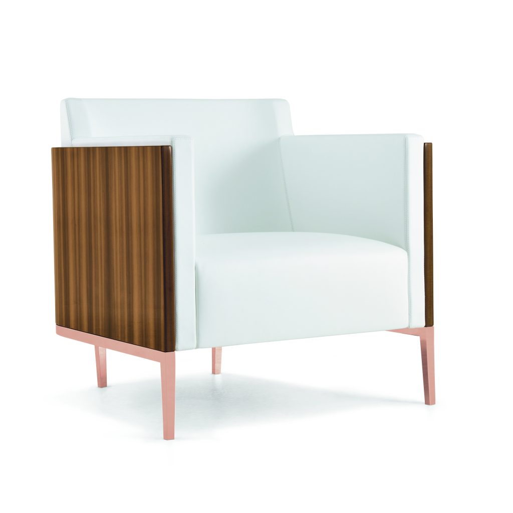 An expansive new showroom inside David Sutherland showcases Christian Liaigre’s collections of lighting and furniture, including this Shelter armchair in larch wood and polished copper.