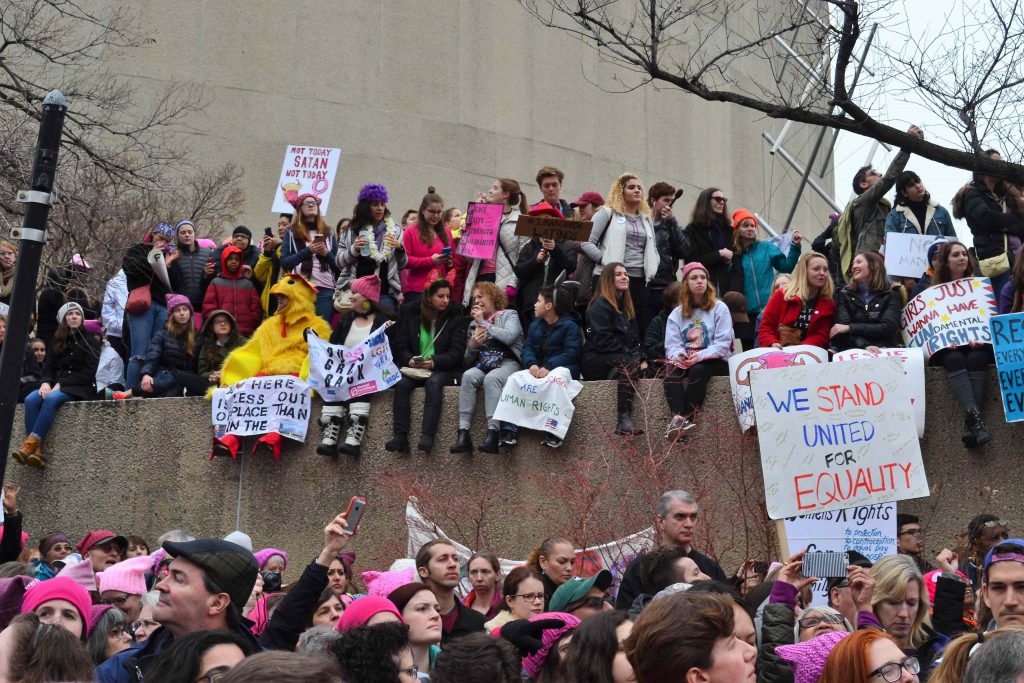An engaged crowd listens to speeches by Steinem, Moore, and Madonna. 