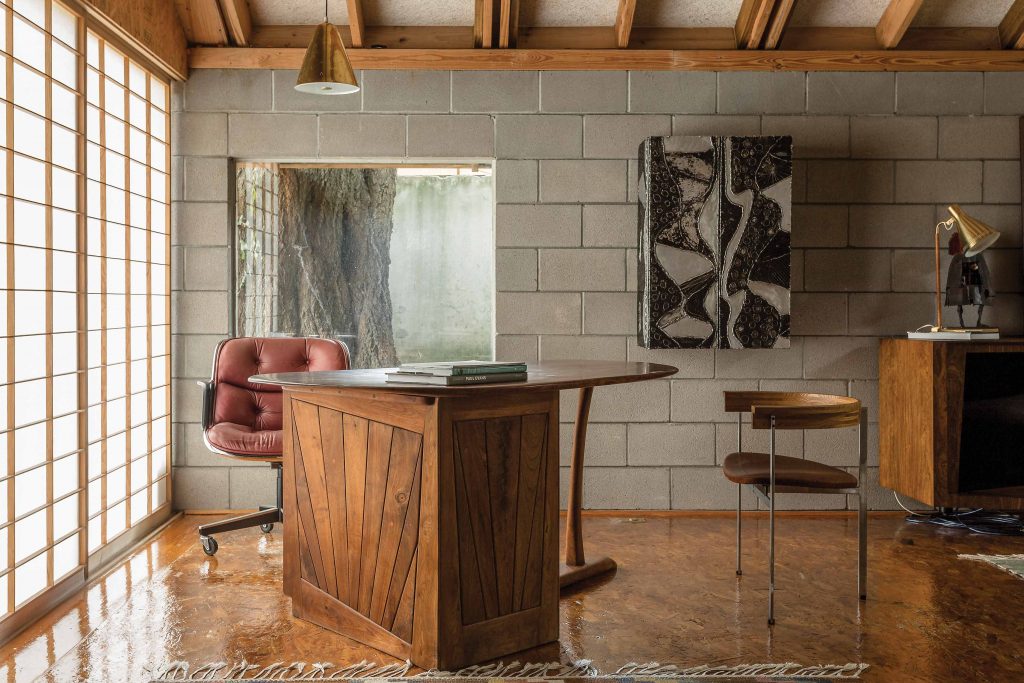 A Shoji screen formed from Fiberglas filters soft light throughout the library, populated by a
Wharton Esherick desk, Poul Kjaerholm chair, and Paul Evans Argente hanging cabinet.