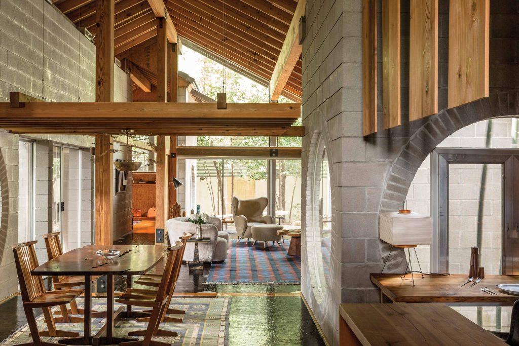 The living room is anchored by a Swedish folk revival carpet by master mid-century weaver Berit Koenig. Nakashima olive-root table, Harry Bertoia sculptures, and Paul Evans pair of Argente cubes also contribute importance to the interior.