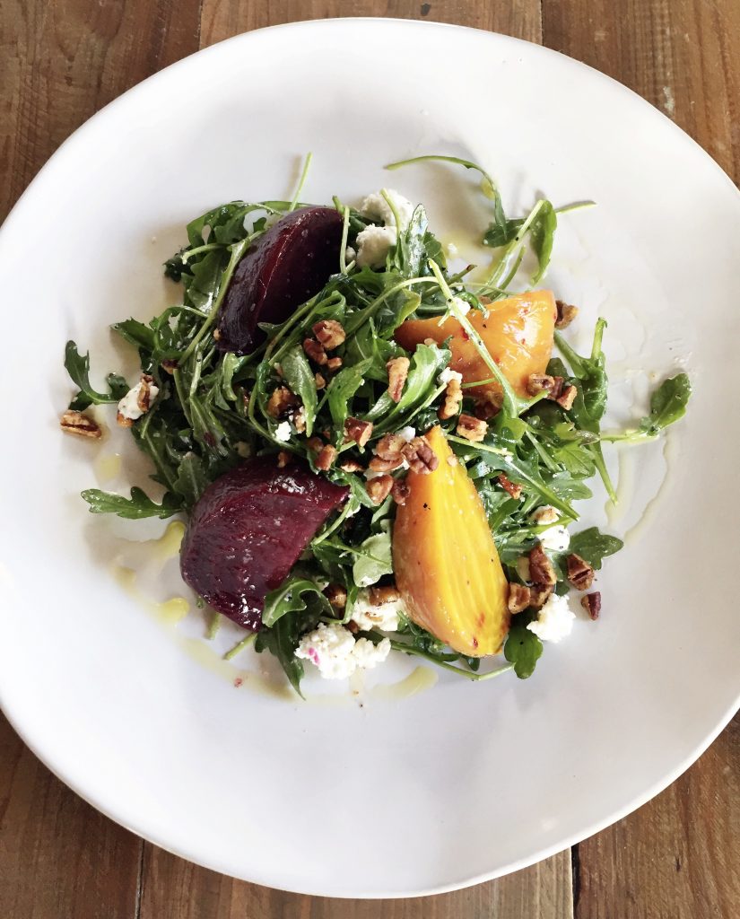 The roasted beets salad is topped with Texas pecans, chevre, olive oil, and sea salt. 