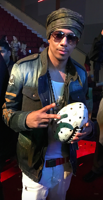 Nick Cannon poses with a MCM x limited edition Super Bowl LI Visetos football, which were displayed inside of the Maxim party. 