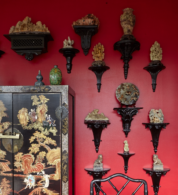 In the dining room, a late-18th-century Chinese gilt cabinet with ivory, stone, mother-of-pearl, and Peking glass inlay. Late-19th-century carved hard stone and jade collection.