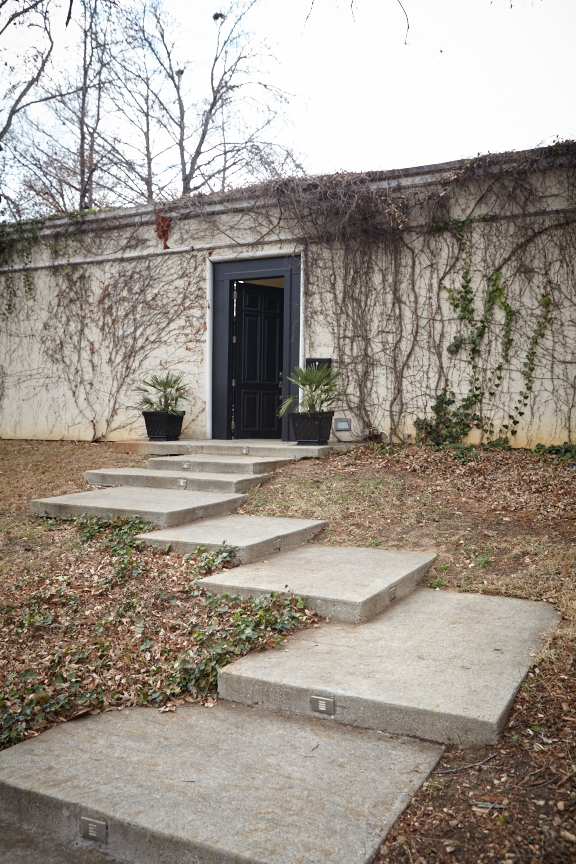 A massive stucco wall shields Loyd Taylor's house from the street.