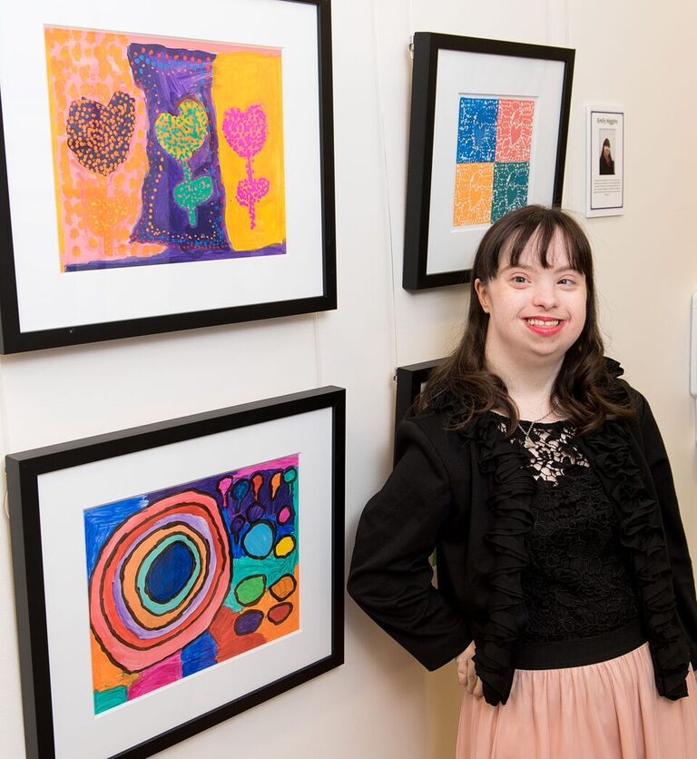Celebration artist Emly Higgins with her vibrant creations. (Photo Mark Katz)