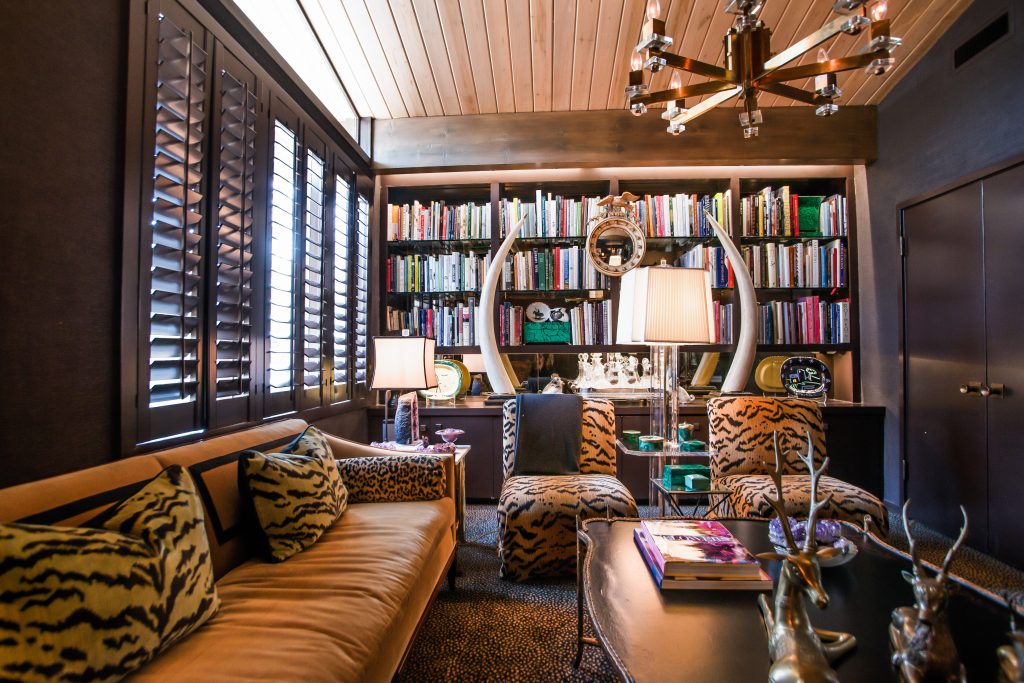 In the library, velvet sofa is from an estate sale. Coffee table from Culp Associates. Scalamandre pillows. Custom slipper chairs. Nineteenth-century bulls-eye mirror from London. Tessellated stone tusks, circa 1980s, from Maitland-Smith. (Photo by Shayna Fontana)