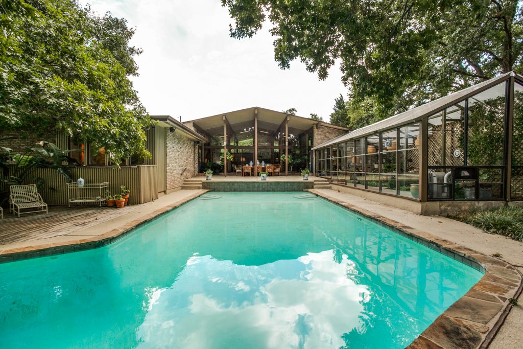 The 1966 house was designed by architect Lyle Rowley. The working greenhouse was originally built for orchids.