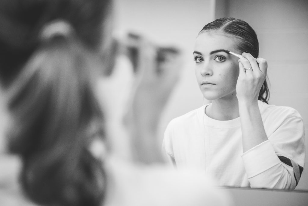 Kuhns darkens her eyebrows when applying full stage makeup.