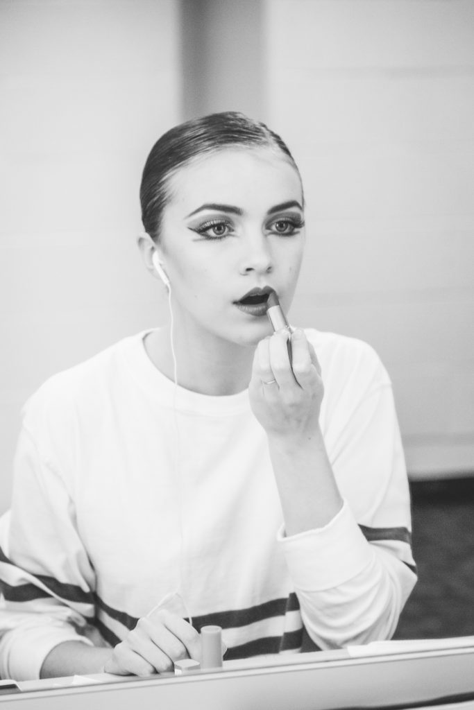 Bridget Kuhns puts on her makeup before heading out toward the stage.