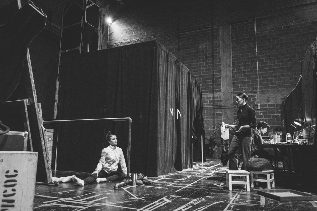 Dressed in warm-up garb, Kuhns stretches backstage.