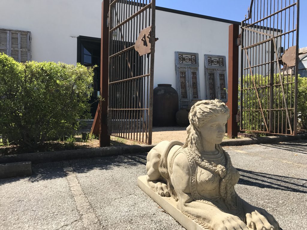 A pair of Sphinx stone statues (only one is pictured here) sit outside the courtyard entrance of the Houston location of Georgia Brown Home, which is closing today.
