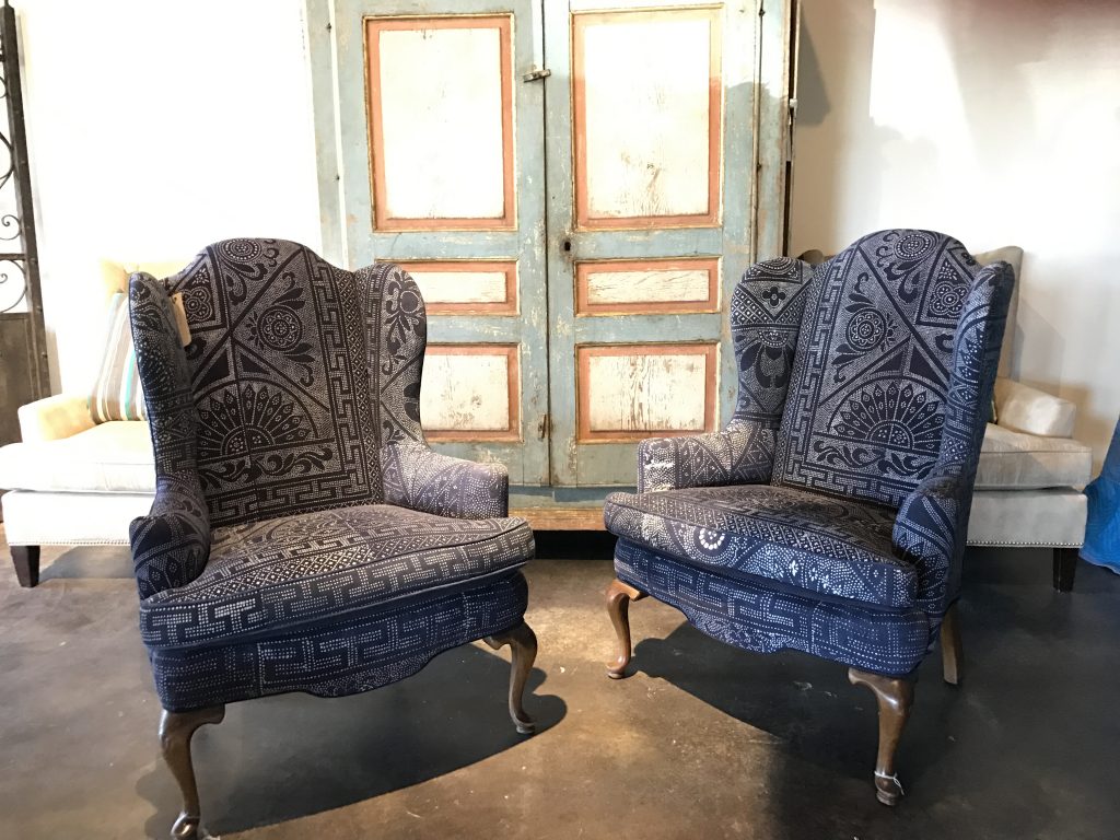 A pair of indigo wingback chairs, that retail for $3,200 each.