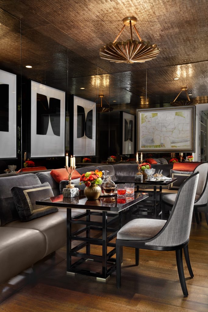 In the drinks room are a banquette in silk velvet, and chairs in Classic Cloth’s Palace Silk velvet and horsehair. Hermès silk-velvet pillows. Macassar-ebony and gold-plated tables,
banquette, and chairs by Cameron from George Cameron Nash. Figurative nude by Venetian artist Giovanni Franzoi, 1994. Charles McMurray’s “Shadow Series,” works on paper, 2010. Ceiling is sheathed in Maya Romanoff’s capiz
shell, and chandelier is by Paul Ferrante, both at George
Cameron Nash.