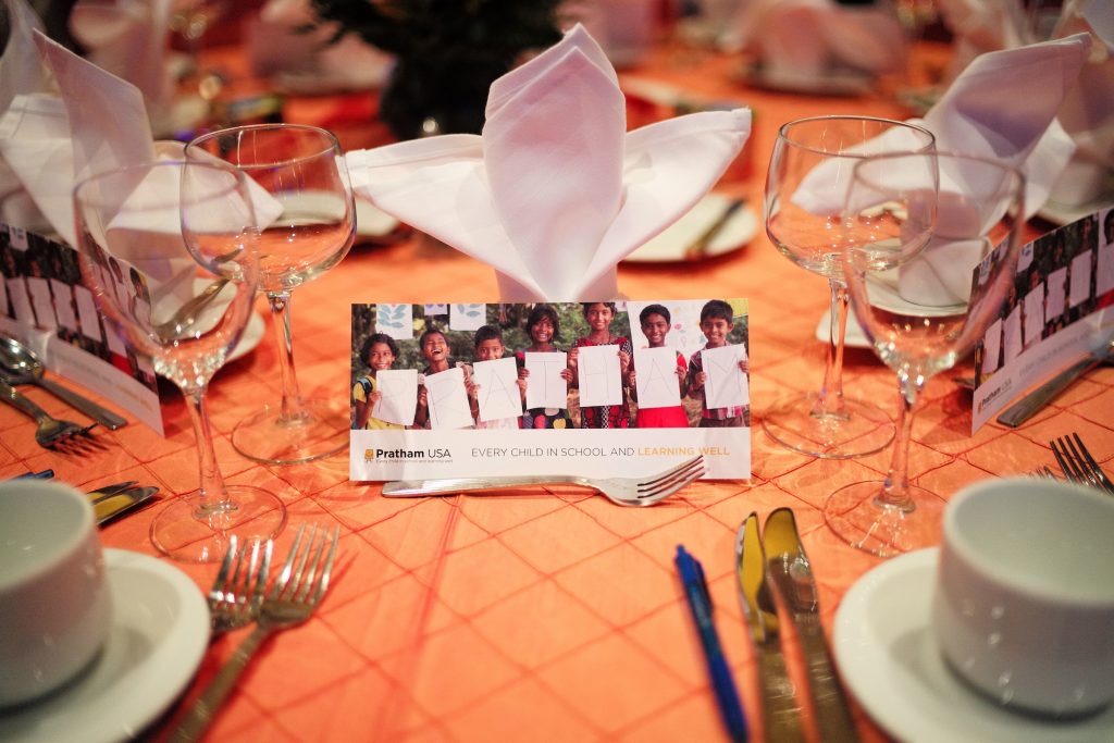 Tables at the gala were graced with images of Pratham students.