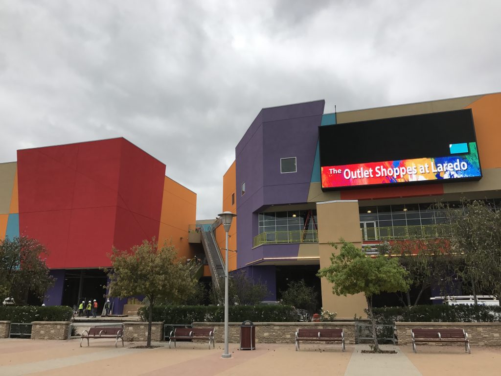 Laredo's new shopping outlet mall next to the Rio Grande features signage facing Mexico.