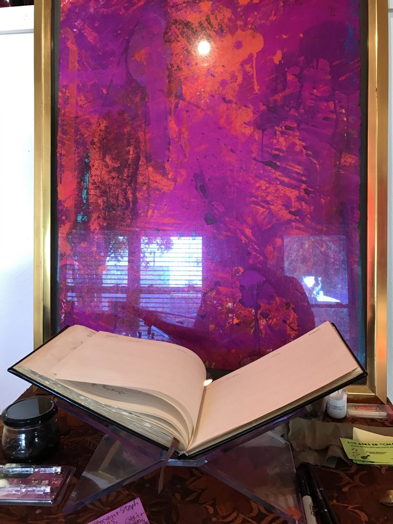 Michael Tracy's work features an intense play of colors and reflections. The River Pierce Foundation guest book is placed in front.  