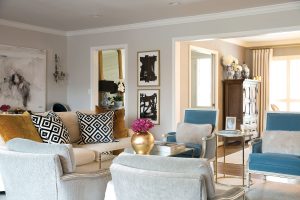 In the living room, an oversized painting by Saba Jawda. David Hicks La Fiorentina and mustard velvet pillows. Sets of inherited reupholstered chairs.