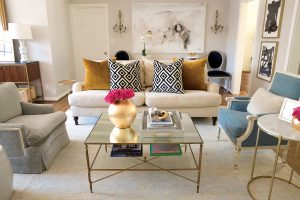 In the living room, an oversized painting by Saba Jawda. David Hicks La Fiorentina and mustard velvet pillows. Sets of inherited reupholstered chairs.