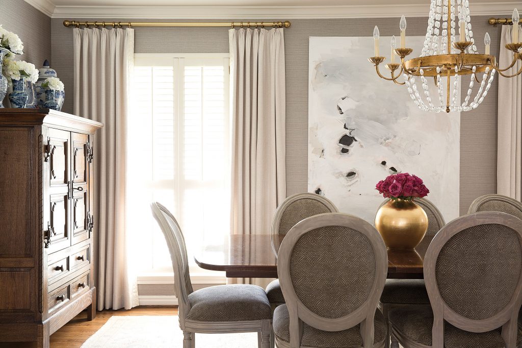 In the dining room, painting by Saba Jawda. Reupholstered French gray chairs and rug from London Grey Rugs.