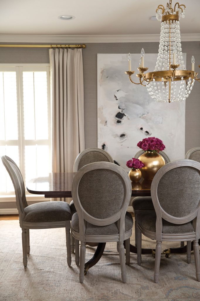 In the dining room, painting by Saba Jawda. Reupholstered French gray chairs and rug from London Grey Rugs.