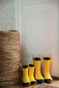 Adorable mother/son pairs of wellies hold court by a natural-fiber catch-all basket in the entry.