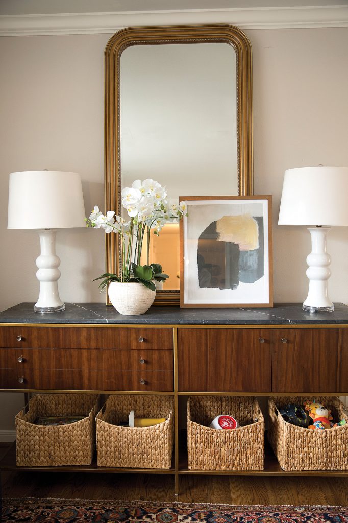In the playroom area off of the living room, a buffet looks aesthetically pleasing but provides easy-access toy storage below.