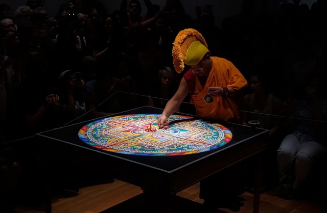 A Tibetan Buddhist Monk in a sand mandala performance at Asia Society Texas Center  