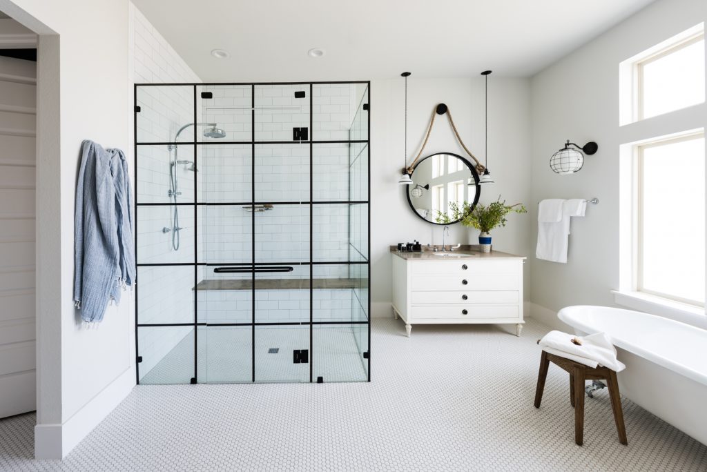 In the master bath, a custom walk-in glass and steel shower by Glasshouse Dallas, and a Raston cast iron clawfoot tub from Signature Hardware (Photo by Manny Rodriguez)
