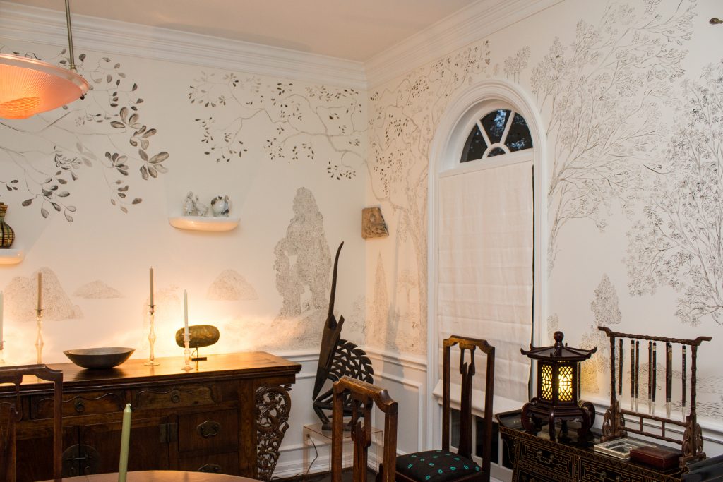 The dining room of the Molyan/Chu home features hand-painted walls devised by the artist. 