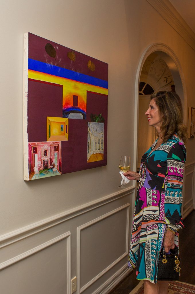 Judith Oudt contemplates a vibrant work. 