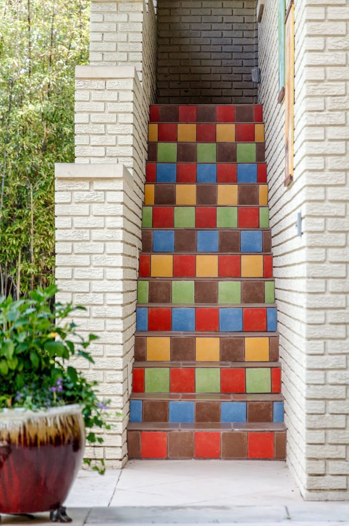 The colorful stairs in the backyard lead to bonus guest quarters.