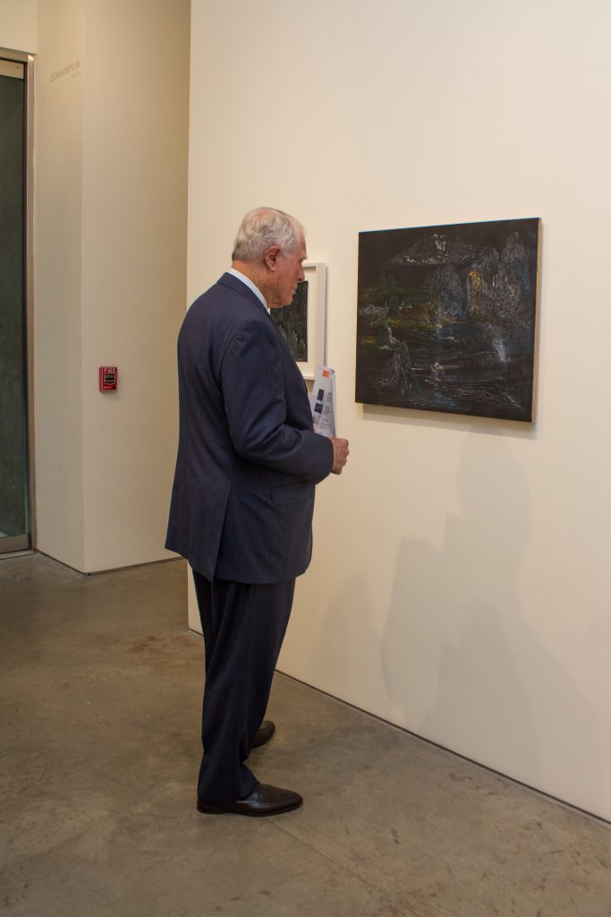 Jim Daniel analyzes a painting. 