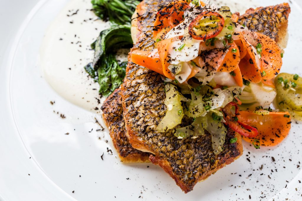 Dorade fish served with tonnato, bok choy, and escebeche