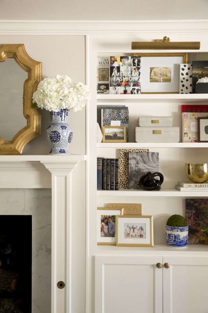 Designers Sarah and Saba Jawda styled the bookshelves, typically following a raid of Longoria Collection for coffee-table books and Aerin shagreen accessories.