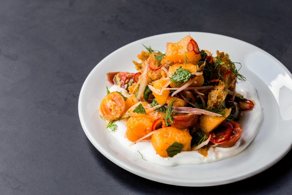 Tomato panzanella, made with canteloupe, labneh, fresnos, and Mint