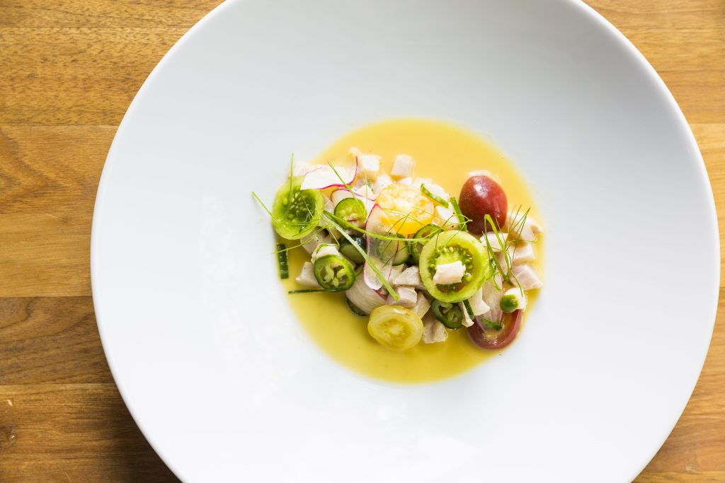 Underbelly's Cobia Ceviche, fashioned with corn milk pickle, tomatoes, and chiles