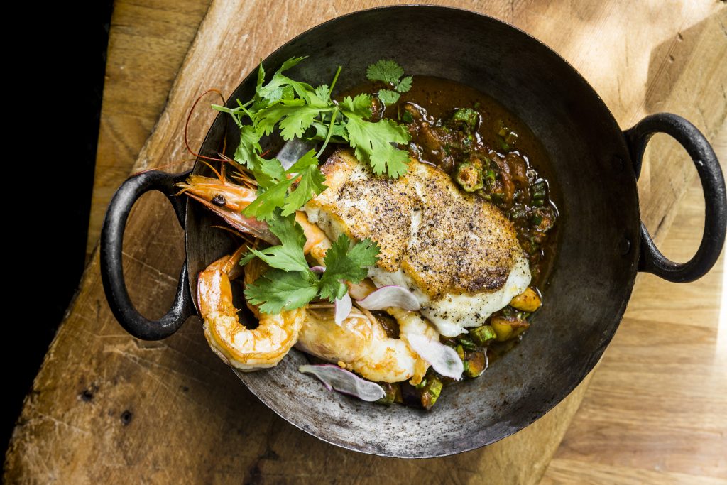 Underbelly's seared red snapper is accompanied by Gulf shrimp handi, okra, and eggplant.