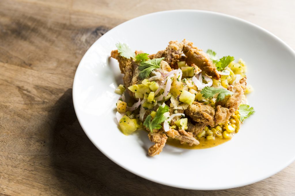 Fried softshell crab over corn maque choux, topped with green tomato relish