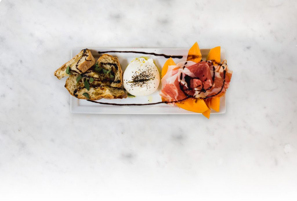 Start your meal at MidiCi with the burrata with Melon & Prosciutto Di Parma. 