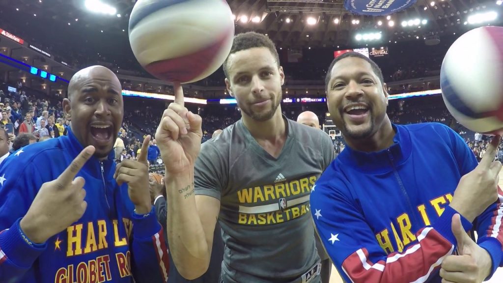 Pictured: Two basketball greats pose with a fan.