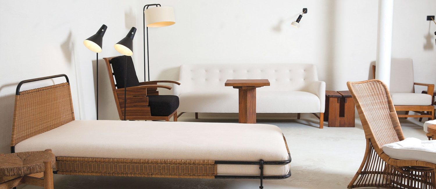 a vignette at Galerie Novella with a French daybed, one of a pair, by Mathieu Matégot. At right, a Louis Sognot wicker chair, also one of a pair.