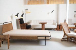 a vignette at Galerie Novella with a French daybed, one of a pair, by Mathieu Matégot. At right, a Louis Sognot wicker chair, also one of a pair.