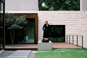 Burberry sculptural coat $2,795, and knitted boot with sculpted heel $925, both at the Burberry boutique, Neiman Marcus, Saks Fifth Avenue, NET-A-PORTER.