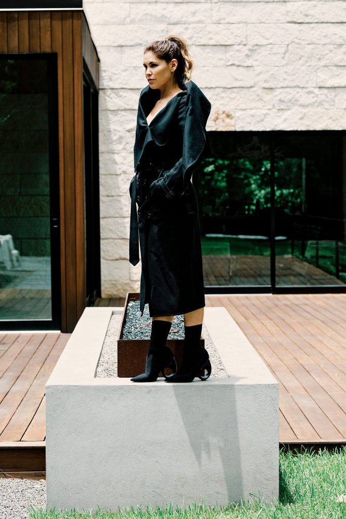 Burberry sculptural coat $2,795, and knitted boot with sculpted heel $925, both at the Burberry boutique, Neiman Marcus, Saks Fifth Avenue, NET-A-PORTER.