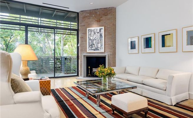 The home is surrounded by lush trees. 