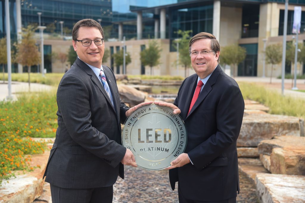 TMNA CEO Jim Lentz (right) receives the LEED Platinum plaque from Jonathan Kraatz (left), executive director, Dallas chapter, U.S. Green Building Council, for green building techniques.