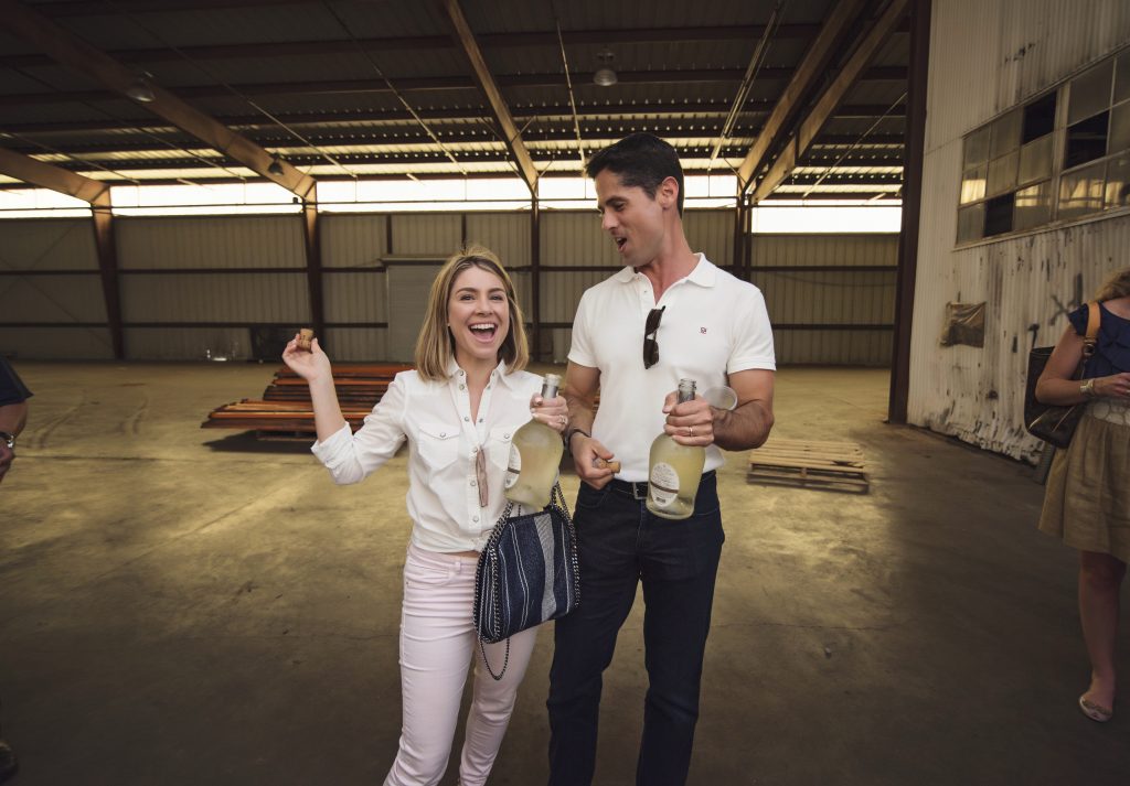 Rachael and Jason Volz toast the new Revaire space. (Photo Brandy Stoesz Photography)